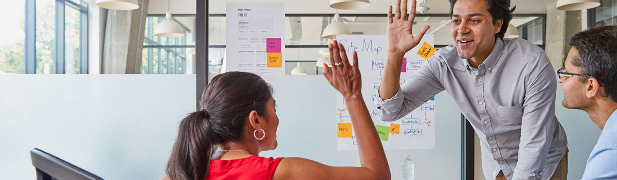 High fives around a conference table